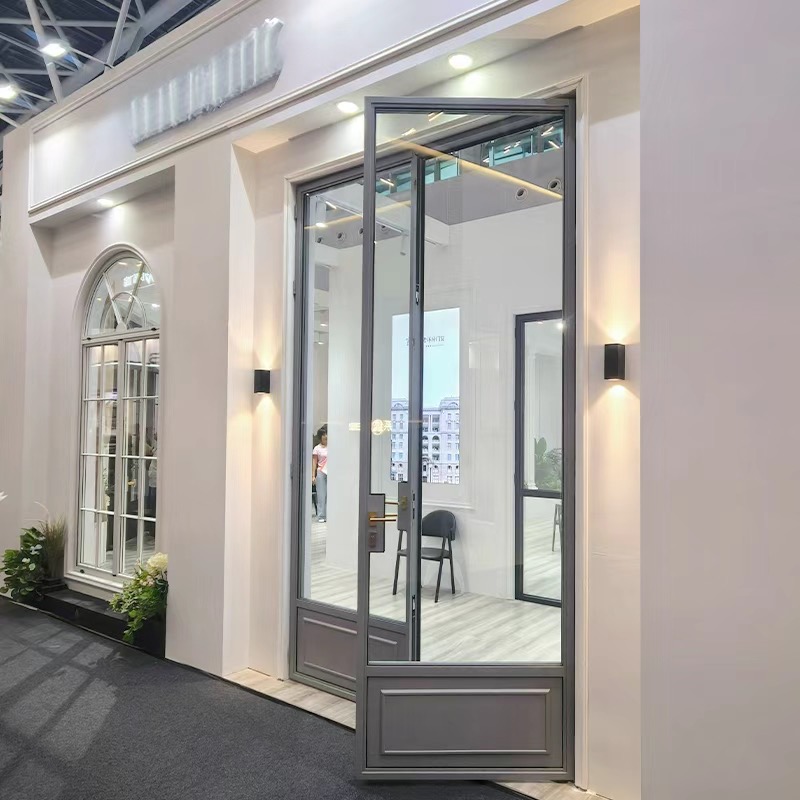 Open slim-profile steel glazed entrance in a showroom setting