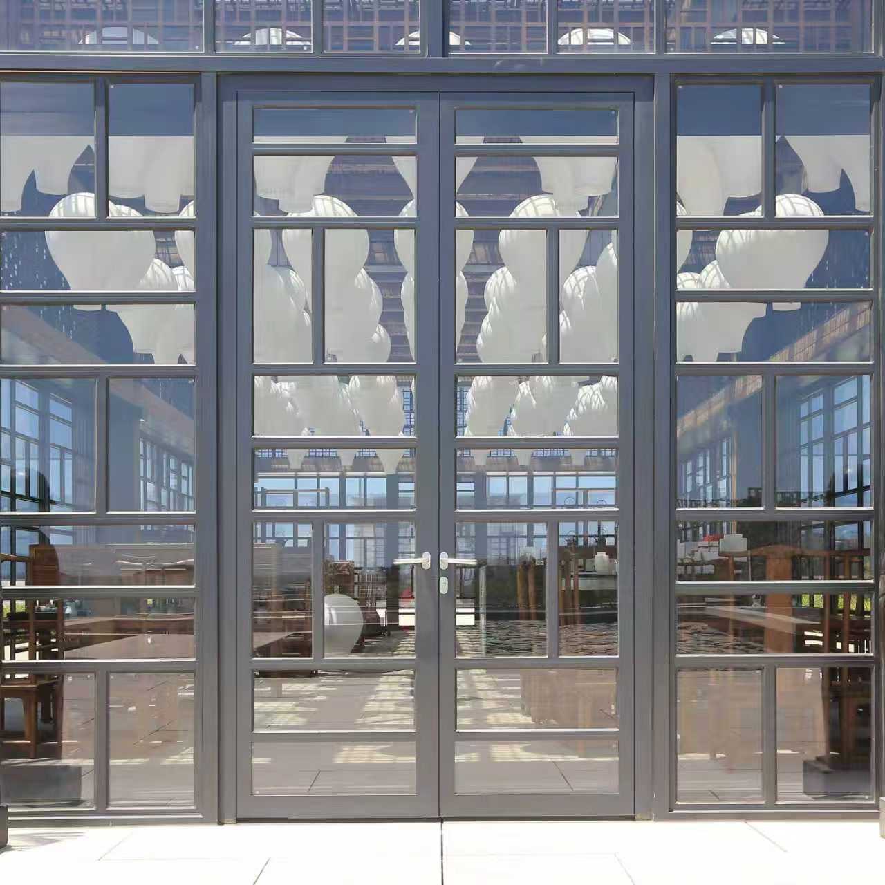 Steel-framed double glazed doors with matching sidelights and transom glazing