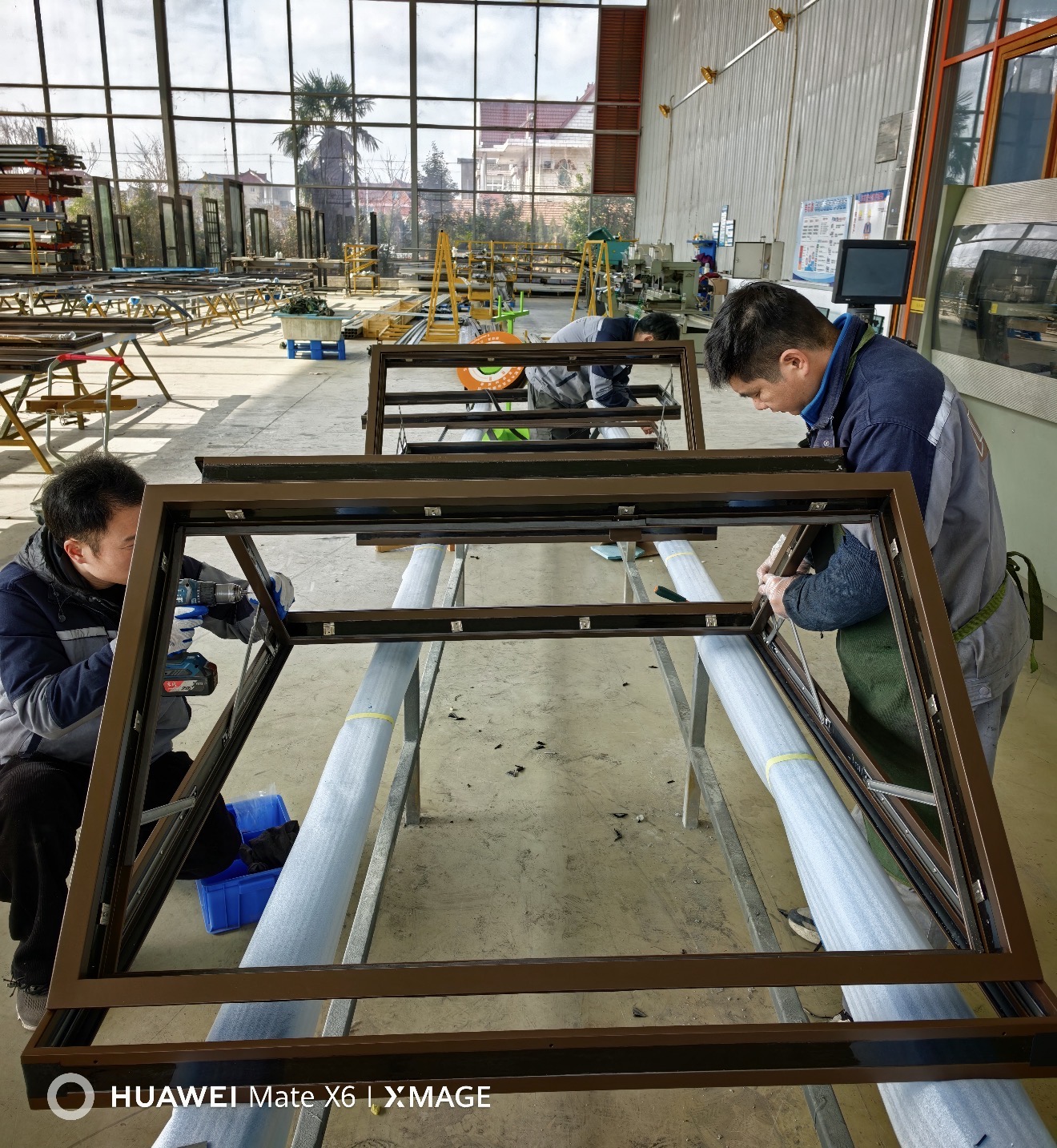 WLS workshop team fitting hardware to bronze-finished metal frames